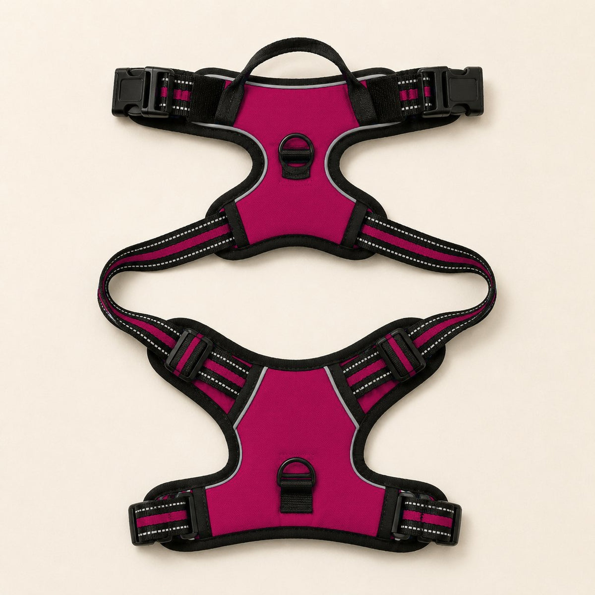 Arnés antitirones RAYGO en fucsia, extendido en plano con las cinchas y las dos anillas a la vista